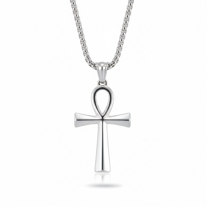 Silver cross pendant on a chain against a white background