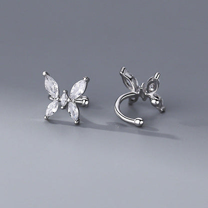 Butterfly-shaped silver earrings on a gray background
