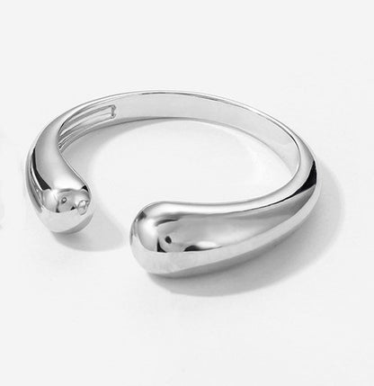 Silver ring with a modern design on a white background