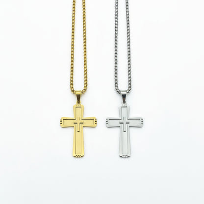 Gold and silver cross pendants on chains against a dark wooden background