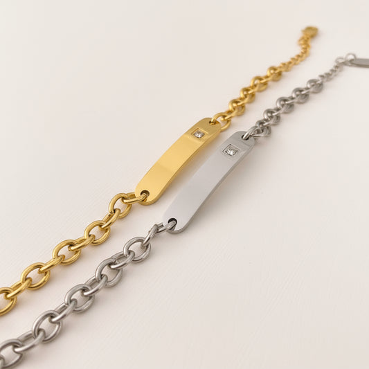 Gold and silver chain Bracelet with diamond accents on a white background