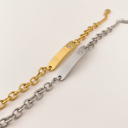 Gold and silver chain Bracelet with diamond accents on a white background