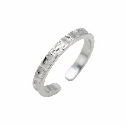 Silver toe ring with small stones on a white background