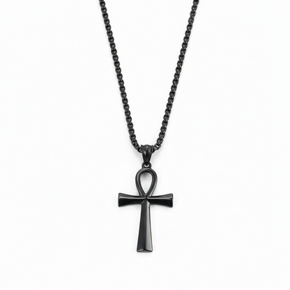 Black cross pendant necklace on a white background