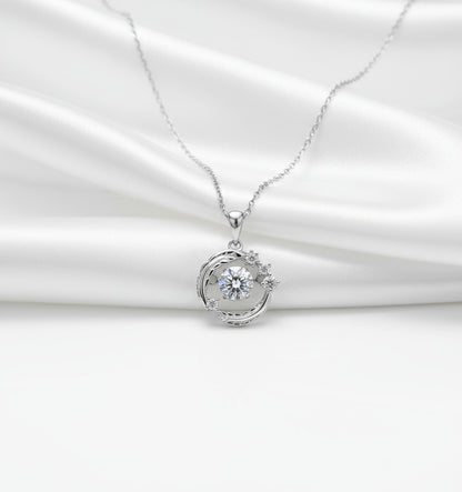 Silver necklace with a round pendant on a black background