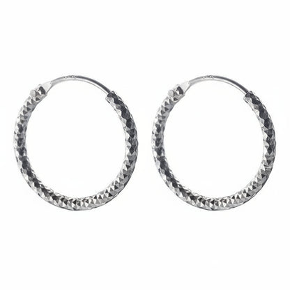 Pair of silver hoop earrings with a textured finish on a white background