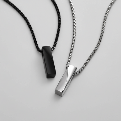 Two necklaces with black and silver pendants on a white background