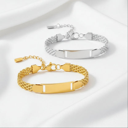 Two gold and silver bracelets with engraved bands on a white background