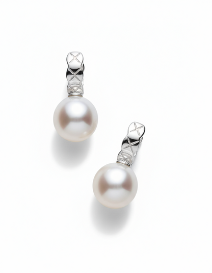 Pair of pearl earrings with silver hooks on a white background