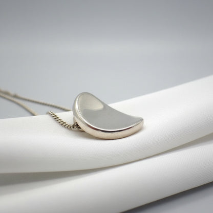 Silver pendant necklace on a white background