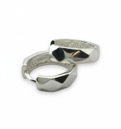 Two silver rings with geometric designs on a white background