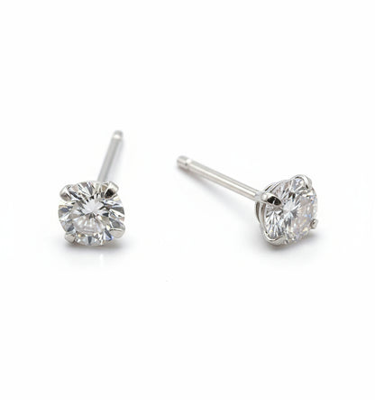 Pair of silver stud earrings with clear gemstones on a white background