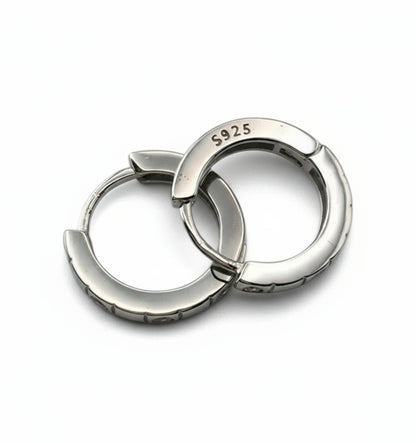 Pair of silver hoop earrings with 'S925' stamp on a white background