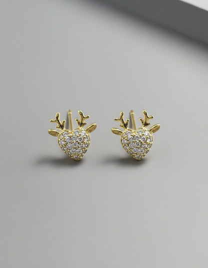 Gold earrings with heart and antler design on a white background